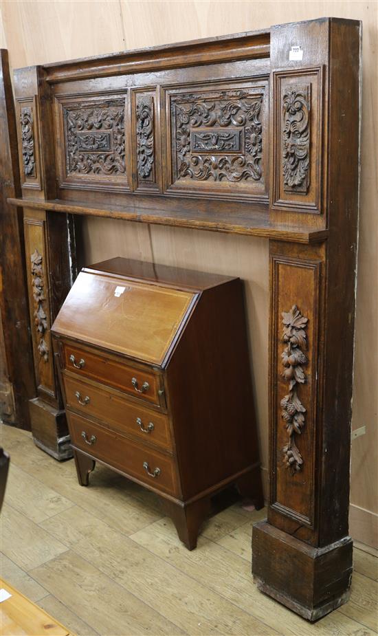 An early 20th century carved oak fire surround, W.188cm H.182cm